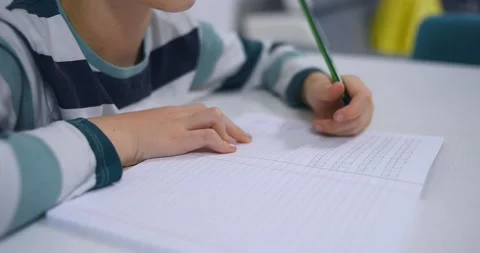 School boy practicing writing the alphabet at home Stock Footage 167795207