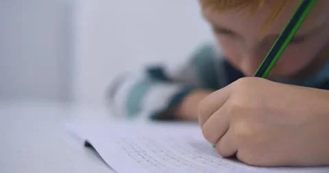 School boy practicing writing the alphabet at home Stock Footage 167795250