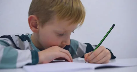 School boy practicing writing the alphabet at home Stock Footage 167795275