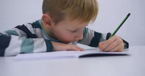 School boy practicing writing the alphabet at home Stock Footage 167795279