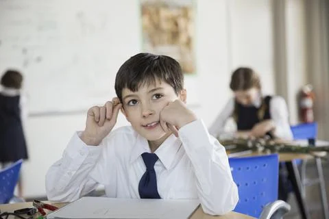School boy problem solving in classroom Foto stock