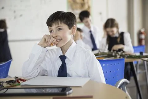 School boy problem solving in classroom Stock Photos