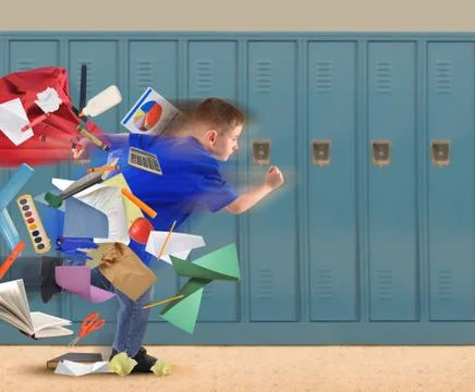 School boy running late with supplies in hallway Stock Photos