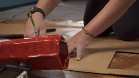 School boy sitting on floor and drawing with pencil. making cardboard homemade Stock Footage 197366645