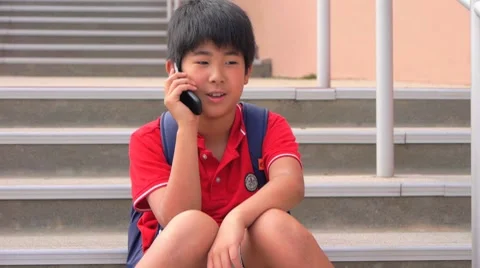 School boy talking on cell phone Stock Footage 7732265