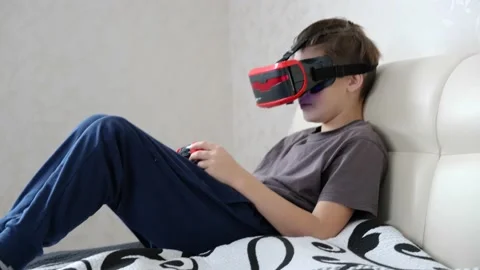School boy using VR glasses and exploring virtual worlds 3D effects Stock Footage 146043465