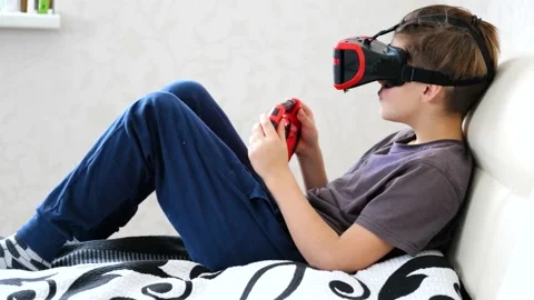 School boy using VR glasses and exploring virtual worlds 3D effects Stock Footage 146043617