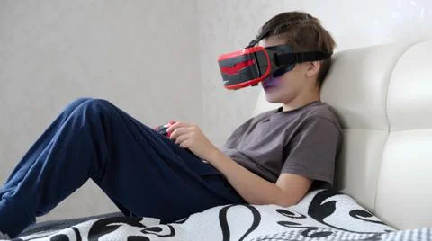 School boy using VR glasses and exploring virtual worlds 3D effects Stock Photos