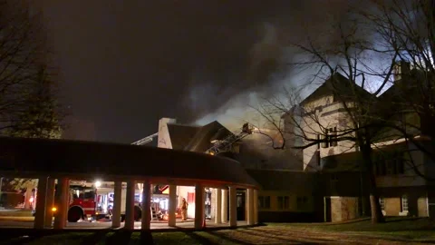 School burning into flames with firefighters and smoke Stock Footage 139657560