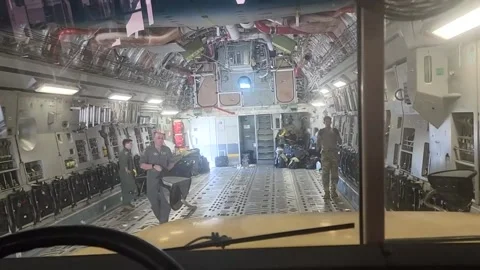 School bus being driven onto C-17 Globemaster aircraft for delivery to Haiti Vídeos de archivo 213922949