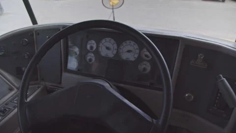 School bus driver station with steering wheel and dashboard gauges Video stock 347731553