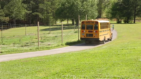 School Bus Drives Away On Small Rural Country Road Stock-Footage 134195092