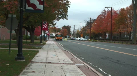 School bus drives down main street in North Haven Stock Footage 44130052