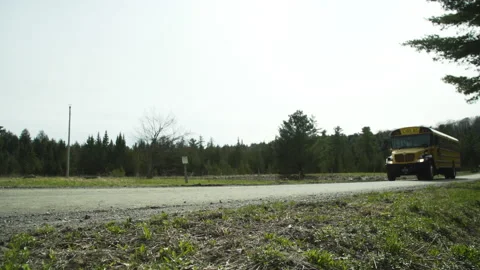 A school bus drives down a rural road Stock Footage 130733245