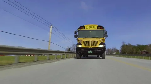 A school bus drives fast down a rural highway Stock Footage 130753494