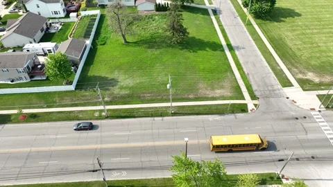 School bus driving down a residential street Stock Footage 242016454