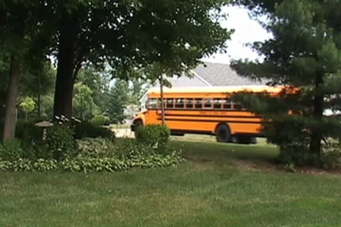 School bus driving down a winding road. 库存影片 7769421