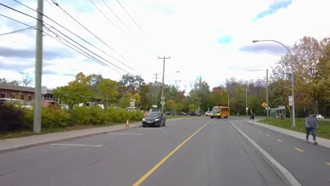 School bus driving next to school during autumn Stock Footage 140885798