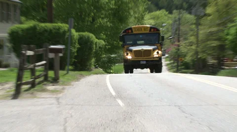 School bus heading down road Stock Footage 32031318