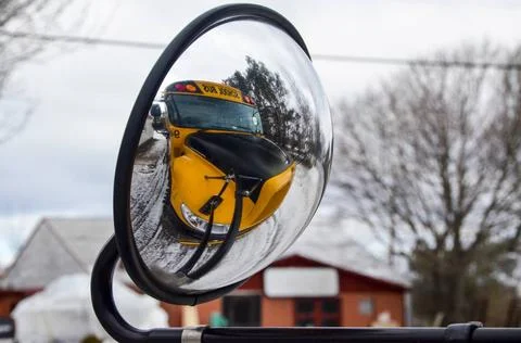 School bus on its own the external mirror Mirroring of the yellow schoolbu... Stock Photos