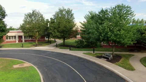 School bus point of view POV entering school building campus, new red Stock Footage 136473401