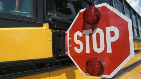 School bus with the stop sign extended and flashing Stock Footage 138120328