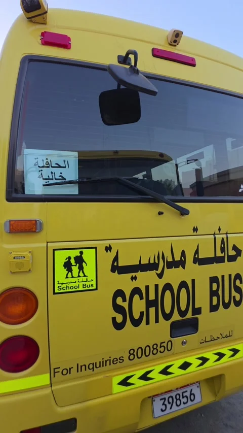 School buses stand in a parking area in Abu Dhabi, UAE. Stock Footage 333980201