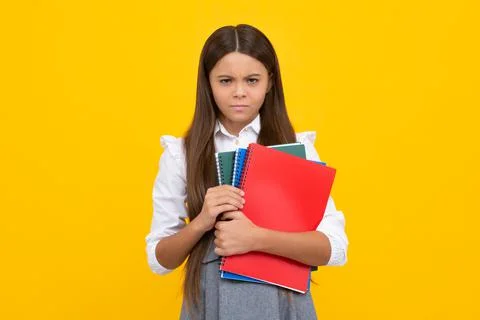 School child with book. Learning and education. Angry teenager schoolgirl, upset Stock Photos