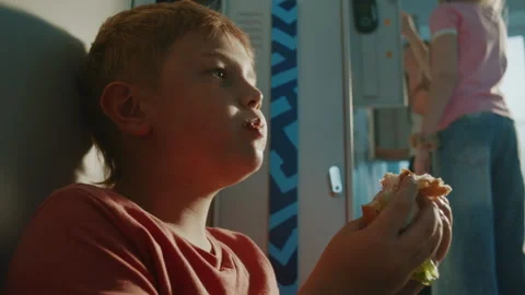 School Child Enjoying Quick Lunch Beside Personal Lockers Between Classes Stock Footage 342025214