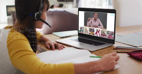In school, child participating in online class with animation on laptop screen 動画素材 303528106