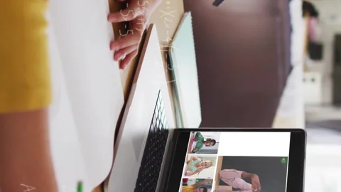 In school, child participating in online class with animation on laptop screen Stock Footage 313296756