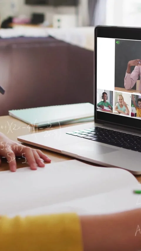 In school, child participating in online class with animation on laptop screen 動画素材 319810983