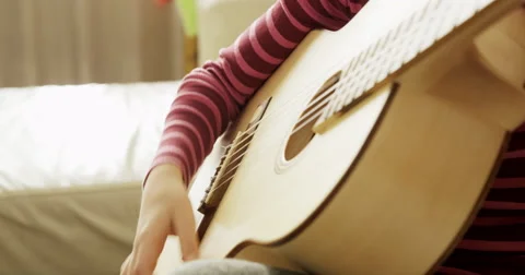 School Child Strumming The Guitar Stock Footage 56100859