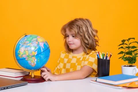 School child student learning in class looking at globe during geography lesson Stock Photos