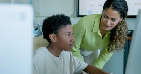 School Child with Teacher in STEM Computer Classroom Looking at Computer Code Stock Footage 286056036
