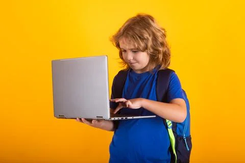 School child using laptop computer. Portrait of cute child school boy. School Fotos Stock