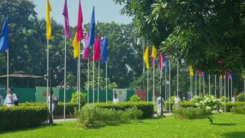 School children dressed in white walk along the pathway outside the Sonargaon Stock Footage 334827970