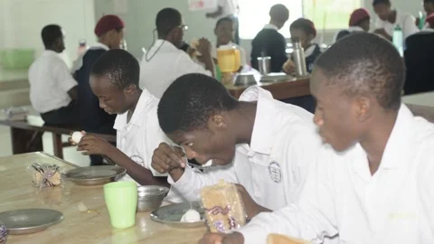 School children  eating their Breakfast Breads,eggs and tea Stock Footage 250179064