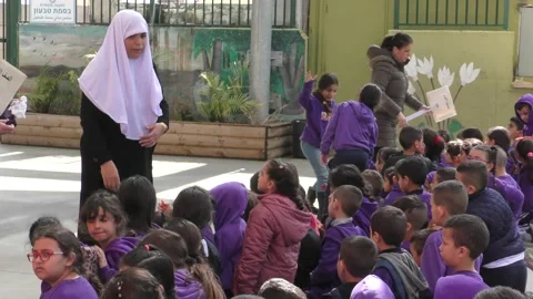 School children in elementary school yard with teachers Видео 135358327