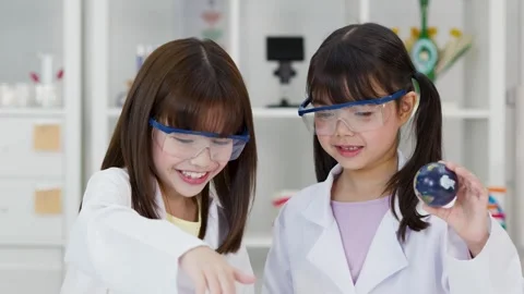 School Children in Lab Coats Learning Astronomy with Solar System Model Stock Footage 341667787