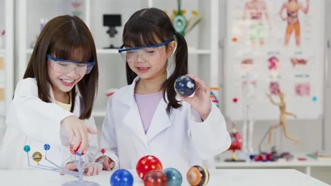 School Children in Lab Coats Studying Solar System Model in Science Classroom Stock Footage 340244344