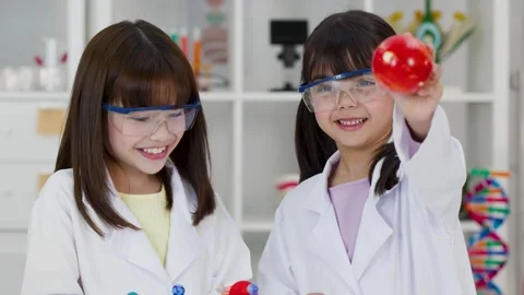 School Children in Lab Coats Studying Solar System Model in Science Classroom Stock Footage 340775179