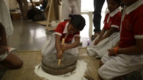 School-children-playing-with-stone-mill-grinder-Slow-Motion Stock Footage 85311488