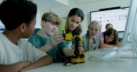 School Children in STEM Computer Classroom, Looking at Robot arm with Teacher Stock Footage 286056449