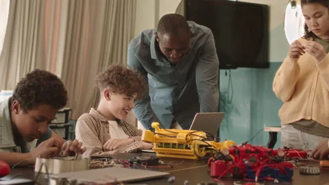 School Children with Teacher Constructing Robots Stock Footage 204895416
