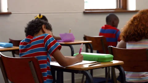 School children writing in classroom Stock Footage 47496278