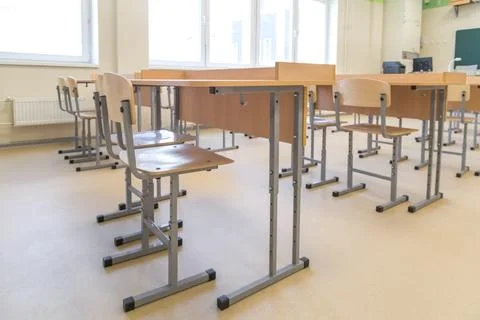 School classroom closed in background without young student, school desks Stock Photos