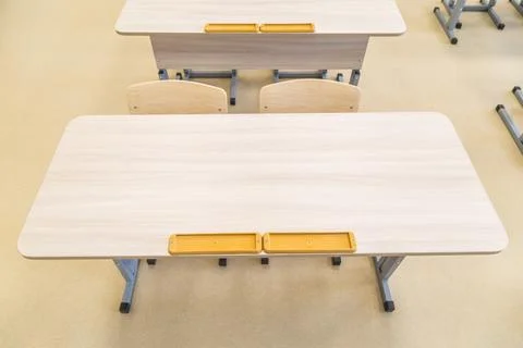 School classroom closed in background without young student, school desks Stock Photos