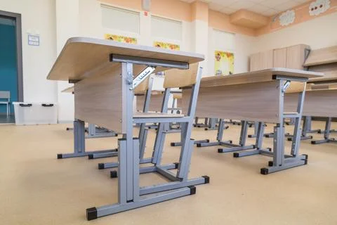 School classroom closed in background without young student, school desks Stock Photos