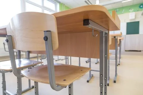 School classroom closed in background without young student, school desks Stock Photos